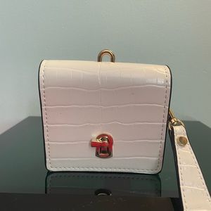 Handheld clutch with detachable strap. Gold tone hardware and key hole lock.